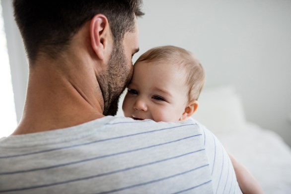 Father holding a baby - parental leave