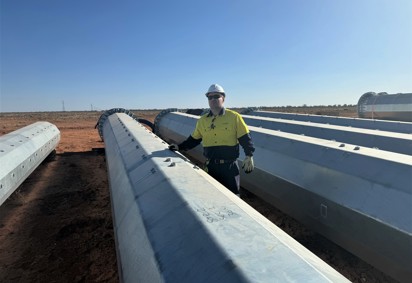 Transgrid Head of Far West Operations Response Sam Pickering inspects the steel structures at Broken Hill