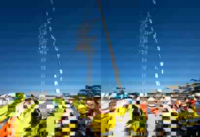 A guyed tower rises on EnergyConnect