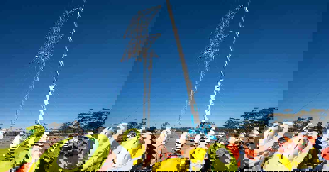 A guyed tower rises on EnergyConnect